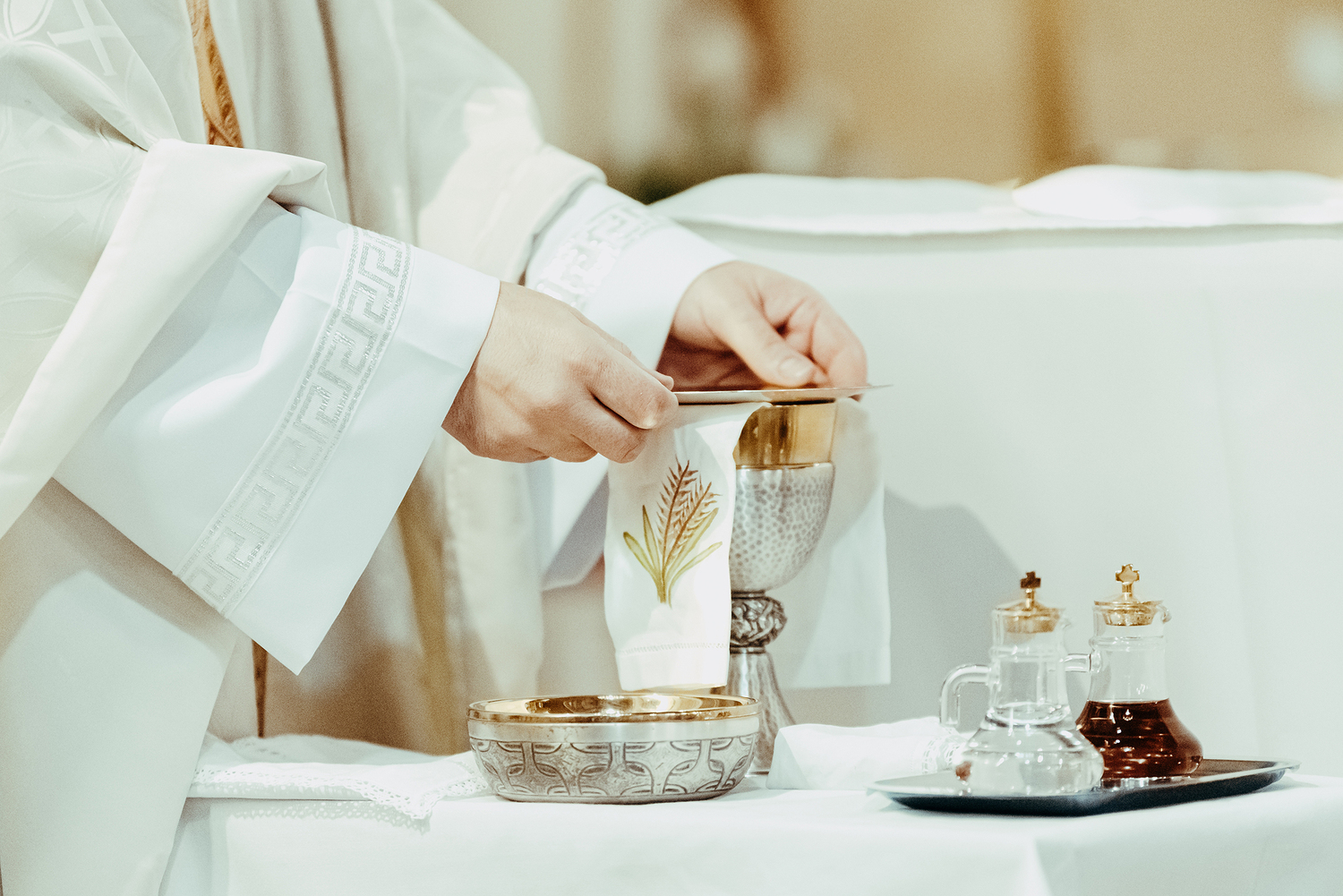 Christian priest prepares the supplies for the consecration liturgy.